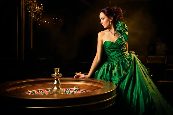 A stylish woman beside vibrant slot machines displaying glowing sevens, showcasing the variety of top slots at LINEBEF.