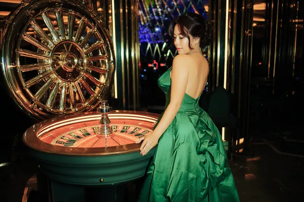 A close-up shot of golden coins falling around a spinning roulette wheel, representing immersive casino action at LINEBEF.