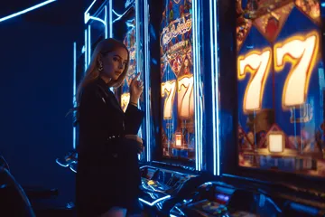 A woman smiling by bright slot machines showing lucky symbols, showcasing the exciting slot offerings at LINEBEF.