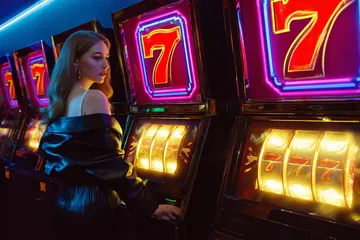 A dramatic shot of winning sevens landing on a slot reel surrounded by shining gold coins, symbolizing big wins.